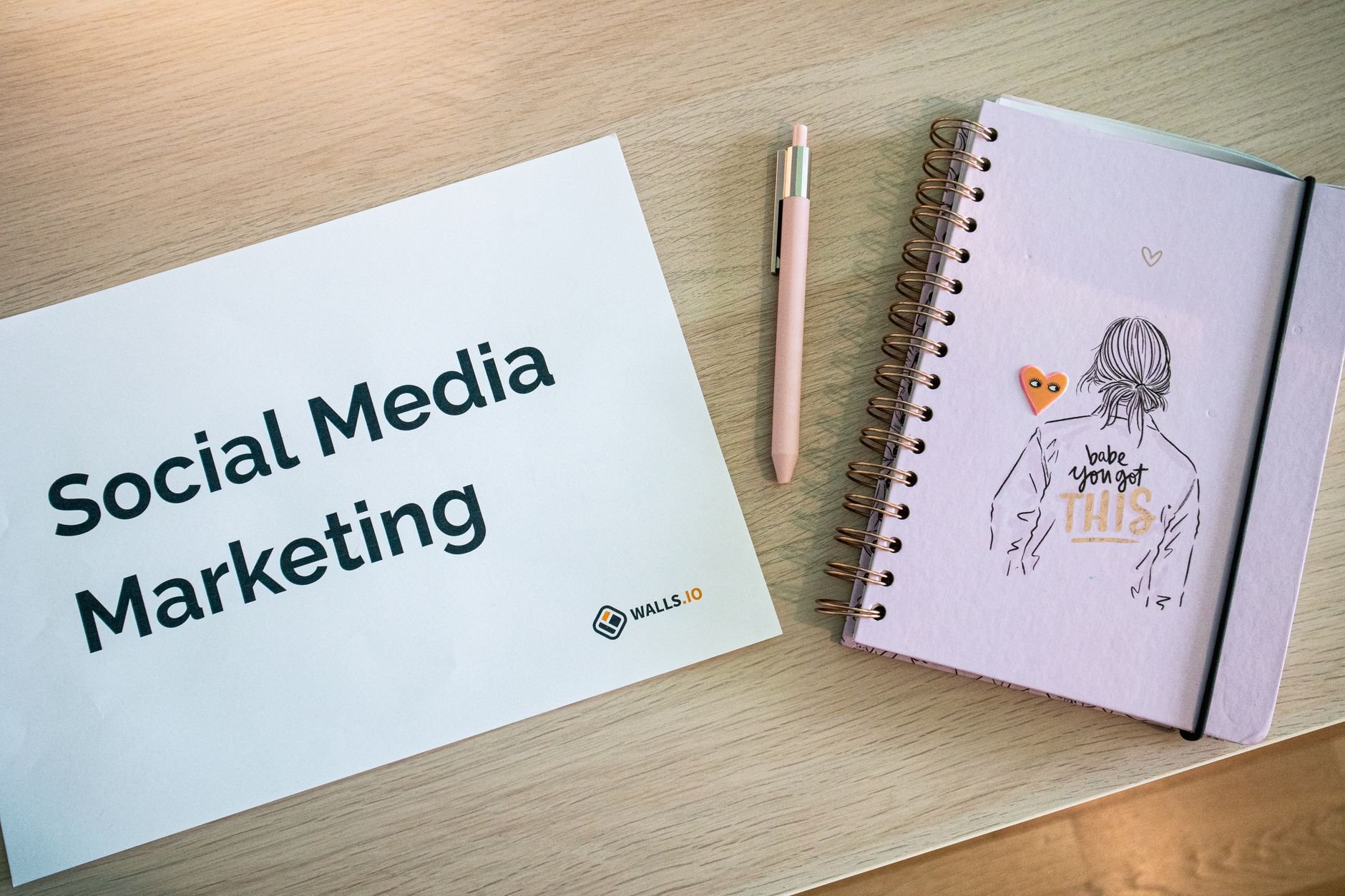 Social media content planning with notebook and phone on desk