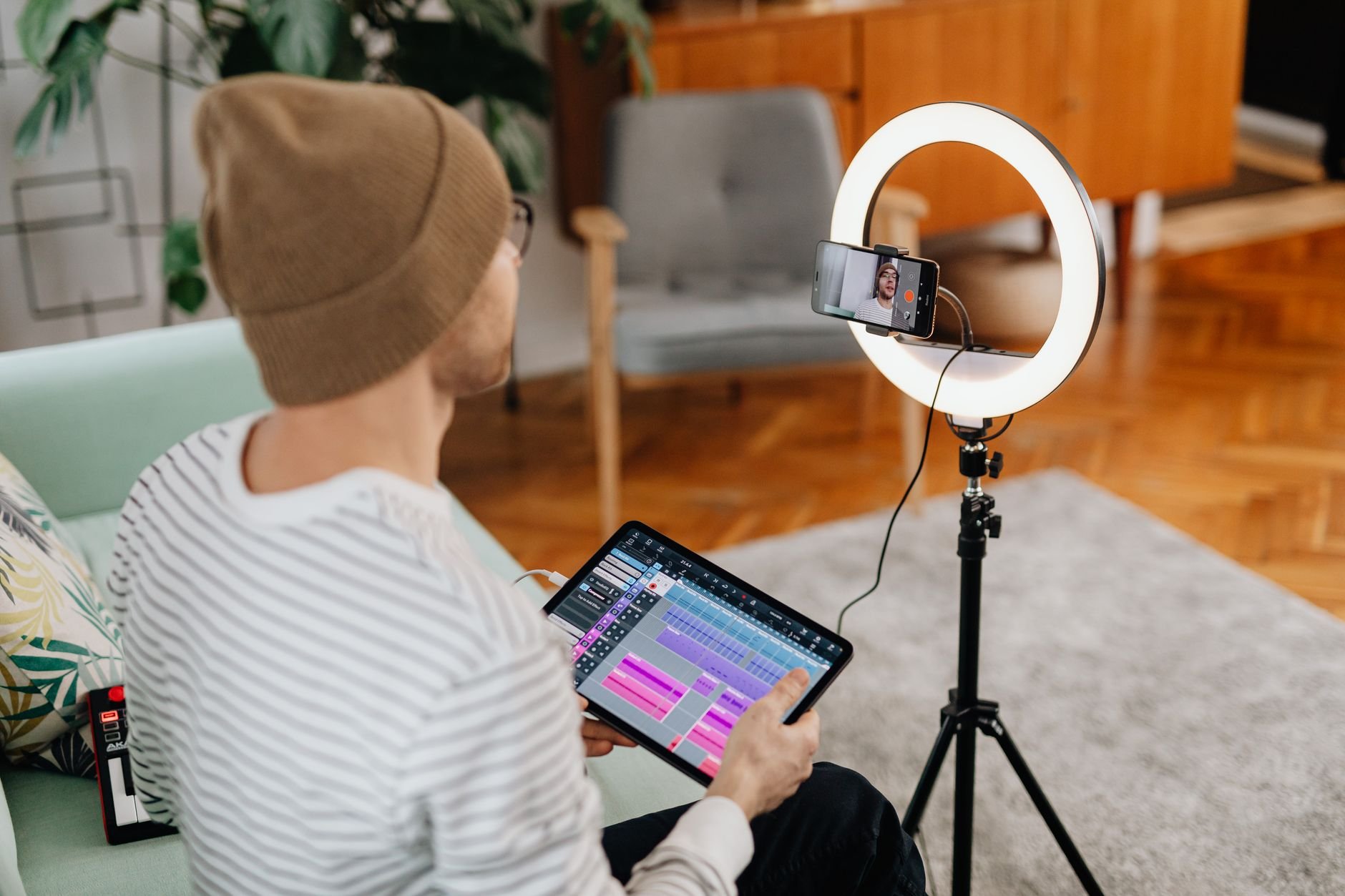 Content creator recording video with ring light in home studio
